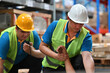© saltdium - Close-up of warehouse workers first aid their friend after accidents or First aid training in an industrial company, safety workplace concept