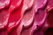 Close-up of glossy red and pink lipgloss swatches with vibrant colors and shiny texture, highlighting the beauty and elegance of professional makeup products.