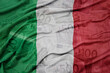 waving colorful national flag of italy on a euro money banknotes background. finance concept.