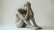 © Theeramisu - sculpture clay sitting while holding hand on the head, emotional breakdown, sad expression
