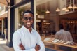 © aicandy - A Smiling Young Entrepreneur Proudly Standing in Front of Their Newly Opened Chic Sunglasses Boutique on a Sunny Afternoon