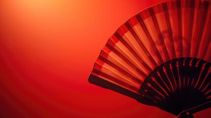 Wall Mural - Close up of a fan on a vibrant red wall, perfect for interior design concepts
