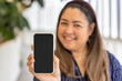 Modern Connectivity for aged people, Middle aged happy smiling Asian Woman hand holding Smartphone with blank black screen, Embracing Technology in Urban Life
