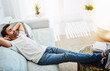 © peopleimages.com - Man, relax and sofa sleeping in home or comfortable peace in living room for afternoon nap, resting or day off. Male person, couch and leisure in England apartment or lazy Saturday, lying or dreaming