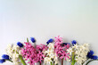 Beautiful spring flowers hyacinths and muscari on a light background, banner.Abstract floral composition, still life with space for text, floral holiday card, summer greeting concept, selective focus