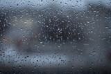 Fototapeta Zachód słońca - Rain drops on window glass closeup macro. Blue Abstract background texture with rain drop