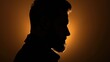 Dramatic silhouette of a man against a backlit background