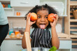 © chokniti - Happy African American Family at Home: Mother and Father Hug Their Young Daughter and Son, Sharing Love and Fun Together, Portraying Cheerful Moments of a Black American Household