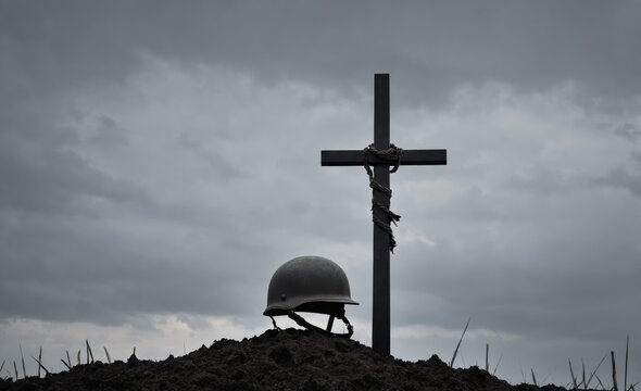 Battlefield memorial with helmet and cross