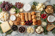 © Jane_S - Variety of cheeses, fruits, and nuts on a wooden board.
