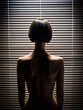 Woman silhouette in blinds shadows. Back of Beautiful Naked Body Girl with short Hair