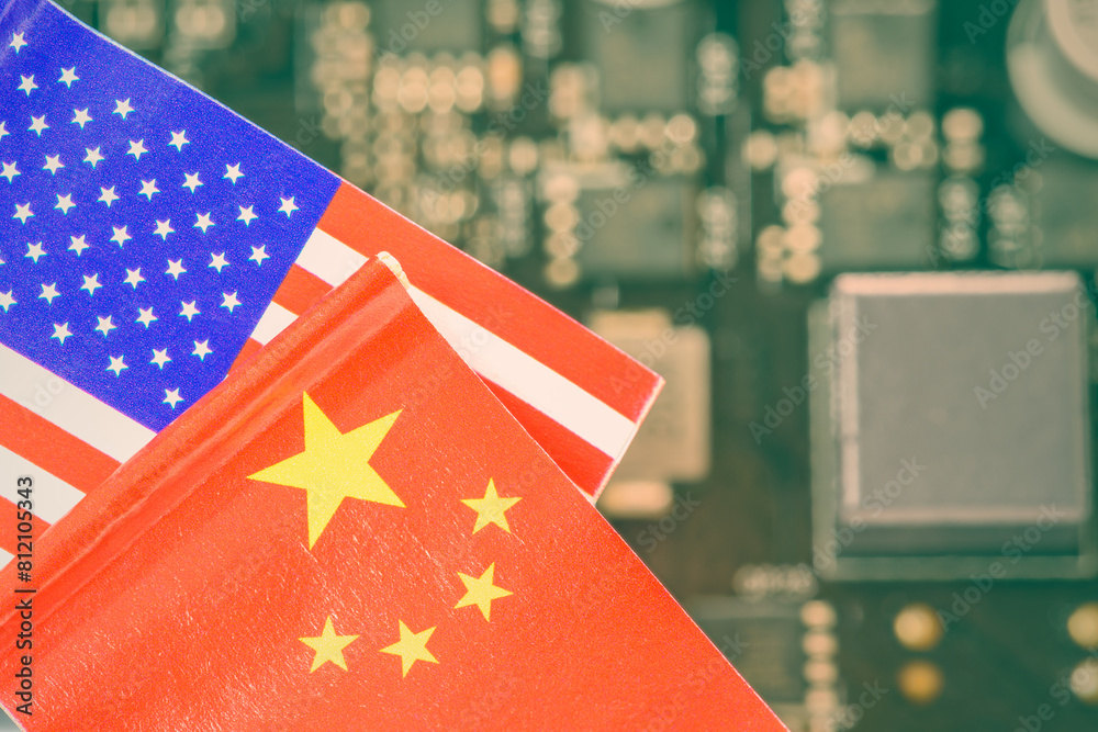 Flags of USA and China fly over a motherboard containing a processor ...