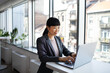 © Marko Geber - Young adult businesswoman working on laptop in office