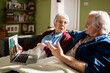 © Marko Geber - Elderly couple having an online conversation with therapist at home