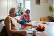 © Marko Geber - Nurse measuring blood pressure of senior patient during home visit
