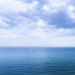Wall Mural - Calm windless ocean in blue tones.