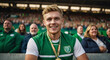Portrait of smiling sportsman in sport stadium after winning medal. Irish football player, man athlete, sports championship