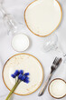 Elegant festive table setting. Set of beautiful cutlery with spring muscari on a marble background, menu layout in a cafe or restaurant, festive composition with a bouquet of hyacinths, 