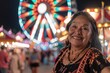A smiling woman posing in front of a brightly lit Ferris wheel at a festive amusement park