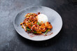 Traditional Thai fried king prawns with vegetable, mango and rice served as close-up on a design plate with text space