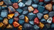 Vibrant Colorful Stones A Striking Black Stone Background with Assorted Hues