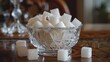 Sugar cubes in elegant glass sugar bowl, perfect for enhancing the sweetness of coffee and desserts