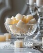 Close-up detailed photo of sugar cubes neatly arranged in a transparent glass sugar bowl