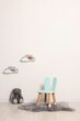 © New Africa - Beautiful children's room with light wall, chair and toys. Interior design