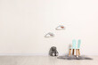 © New Africa - Beautiful children's room with light wall, chair and toys, space for text. Interior design