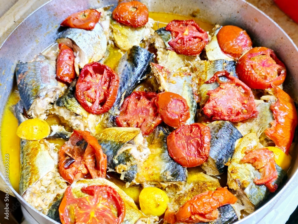 Mackerel fish, baked and cooked with tomatoes, different species of ...