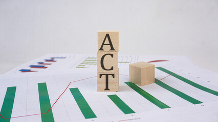 ACT - word is made of wooden building blocks with economic graphic Business, economic concept, white background