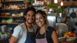 Smiling young hispanic couple posing at their restaurant