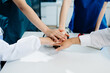 © laddawan - Team Doctors nurses union coordinate hands Teamwork Concept in hospital for success and trust