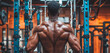 © Sachin - Focused African-American male bodybuilder working out at gym, performing cable machine exercises