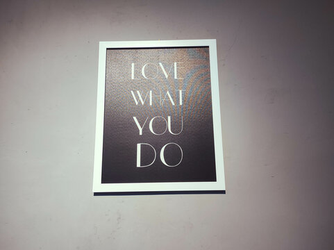 posters of motivational words with white frames stuck to the wall