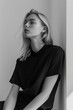 © Keitma - B&W minimalist elegance with a blonde caucasian female model. Woman poses in a sleek and modern setting, dressed in monochrome separates, clean lines, embodying timeless sophistication and simplicity
