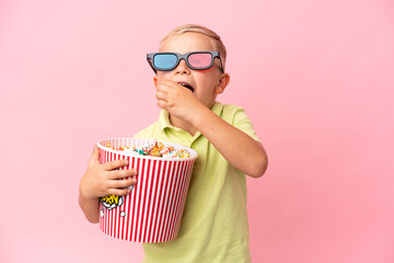 Wall Mural - Little Russian boy eating popcorns in a big bowl over isolated background