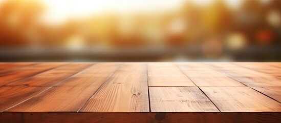 Poster - An empty wooden table with a blurred abstract background providing ample copy space for text marketing promotions