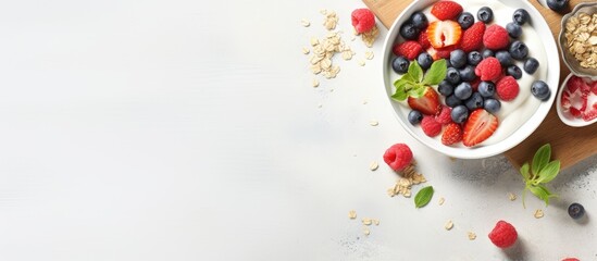 Poster - An overhead shot of a healthy breakfast consisting of homemade granola topped with yogurt and fresh berries presented in a flat lay style with plenty of negative space for text or other elements