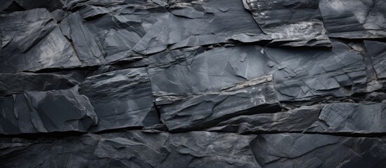 Poster - An abstract background or texture featuring a black stone on a slate like surface Perfect for copy space images
