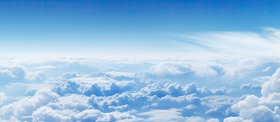 Poster - A breathtaking sight of clouds fills the frame as seen from the window of an airplane creating a captivating copy space image