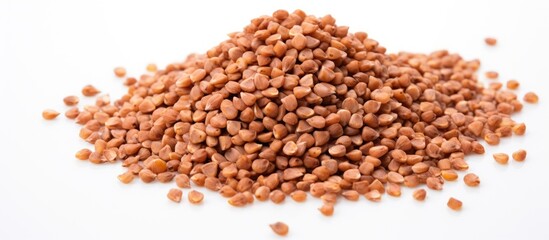 Poster - A bunch of healthy dried buckwheat grains on a white background with ample copy space in the image