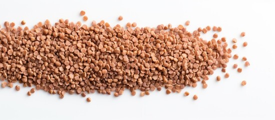 Poster - A bunch of healthy dried buckwheat grains on a white background with ample copy space in the image