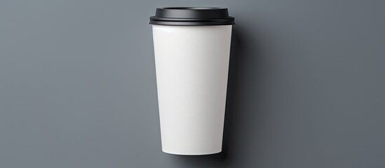 Poster - A disposable coffee cup with a closed plastic lid designed to be easily recycled This takeaway drink is showcased in a flat lay on a gray background creating a mock up image with plenty of copy space