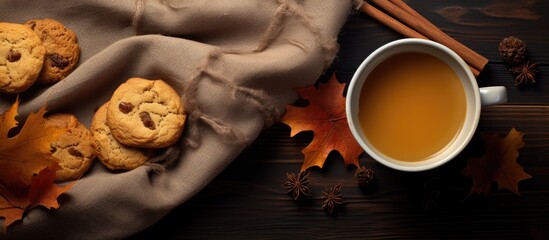 Aufkleber - Top view of a cozy autumn scene featuring a cup of tea a warm scarf and delicious cookies all surrounded by a copy space image