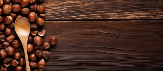 Aufkleber - A top down view of a spoon filled with shelled hazelnuts rests on a rustic wooden surface providing ample copy space for your textual needs