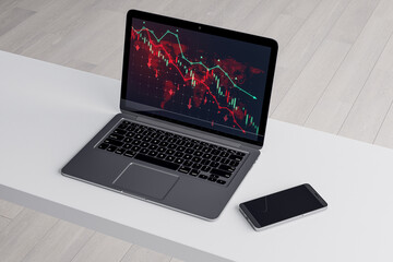 Wall Mural - Close up of white office desk with smartphone and downward red forex chart on laptop screen. Blurry background. Stock, trade and report concept. 3D Rendering.