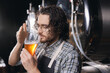 Expert brewer Sommeliers taste craft beer from brewery factory