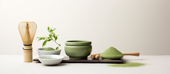 Poster - A copy space image featuring matcha powder and tea ceremony tools arranged on a white background