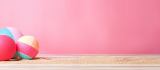 Sticker - A copy space image featuring beach ball and sand toys arranged on a pink wooden background perfect for adding text